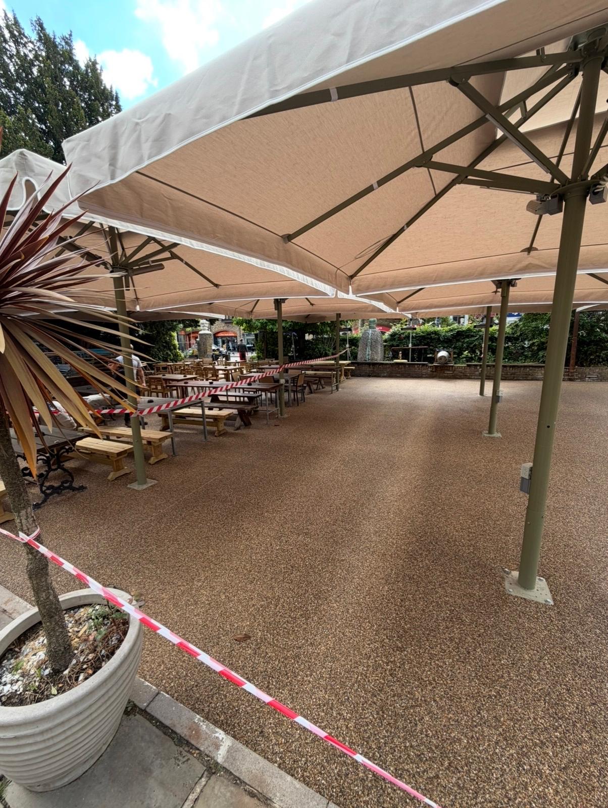 Resin flooring and parasols in the refurbished garden