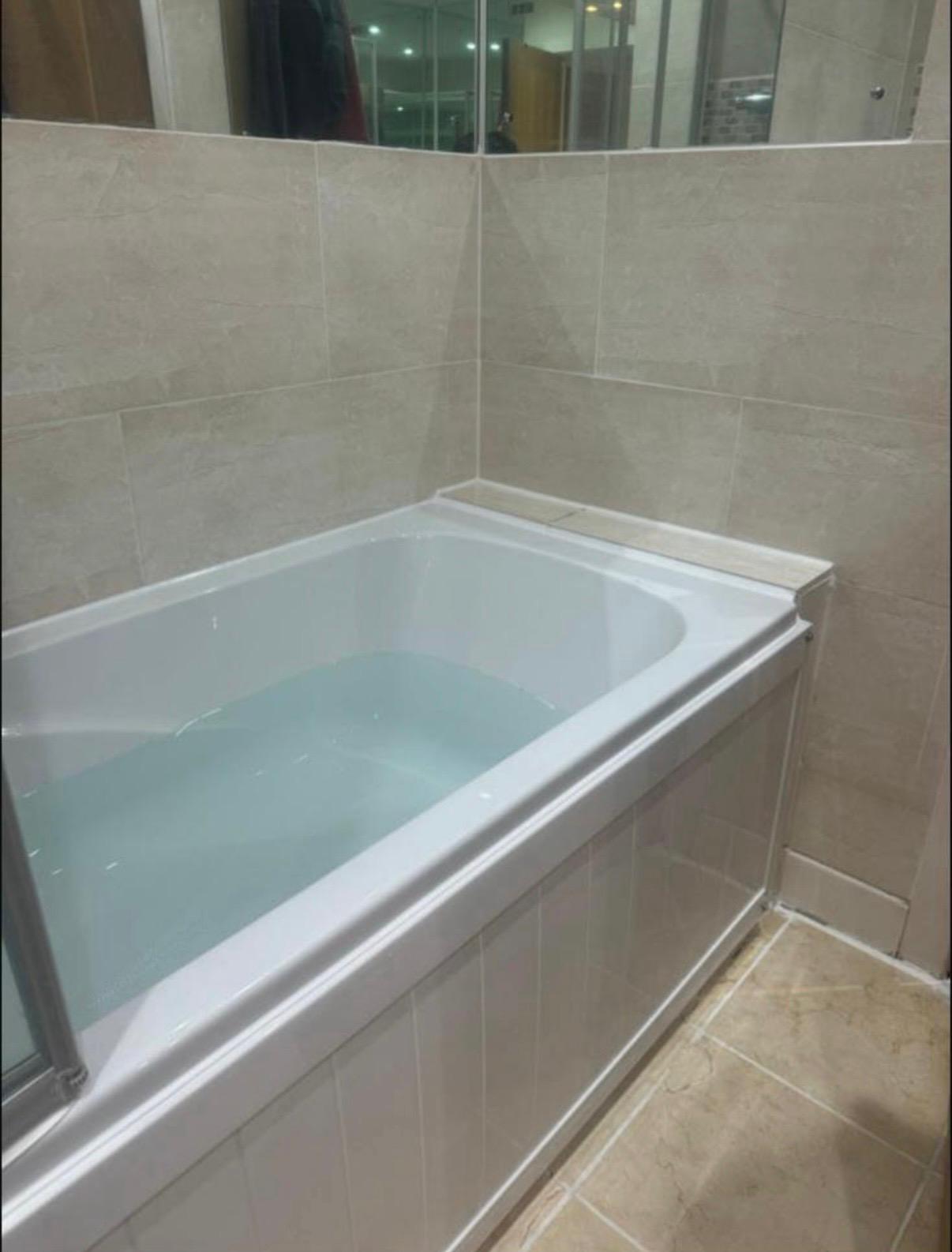 Refurbished tiled bathroom with newly fitted bath, London property maintenance