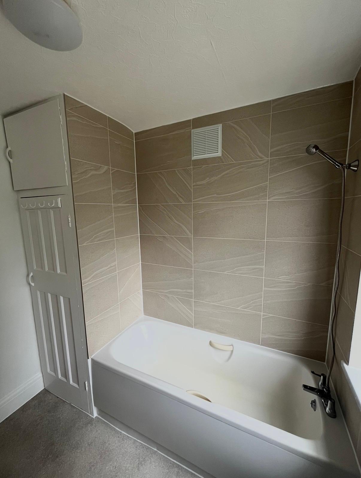 Tiled bath with surround in a panelled bathroom, London & Essex